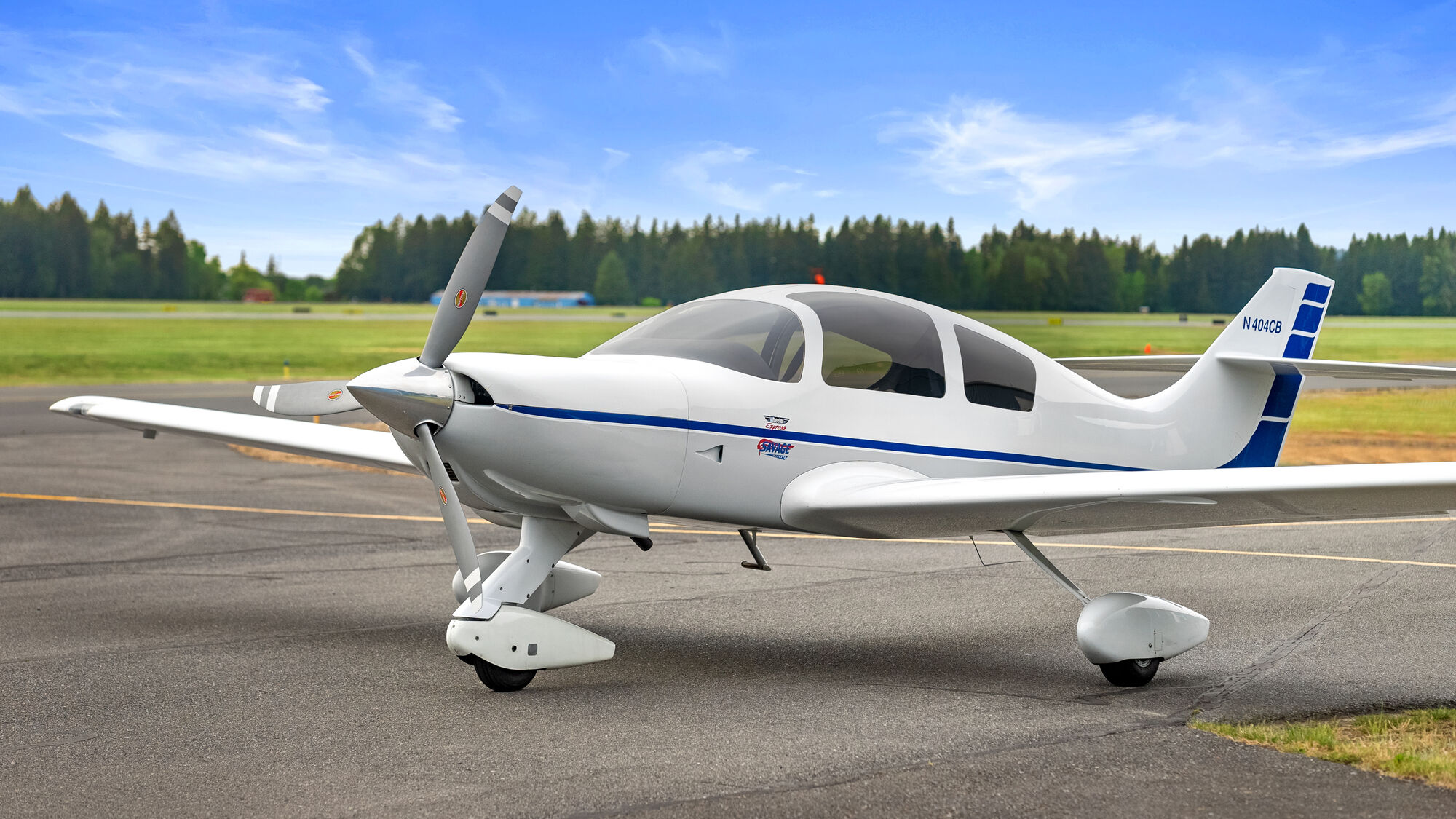 Wheeler Express single-engine aircraft by a blue hangar